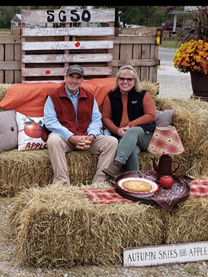 Happy couple enjoying outdoor lounging area made from Hay bales